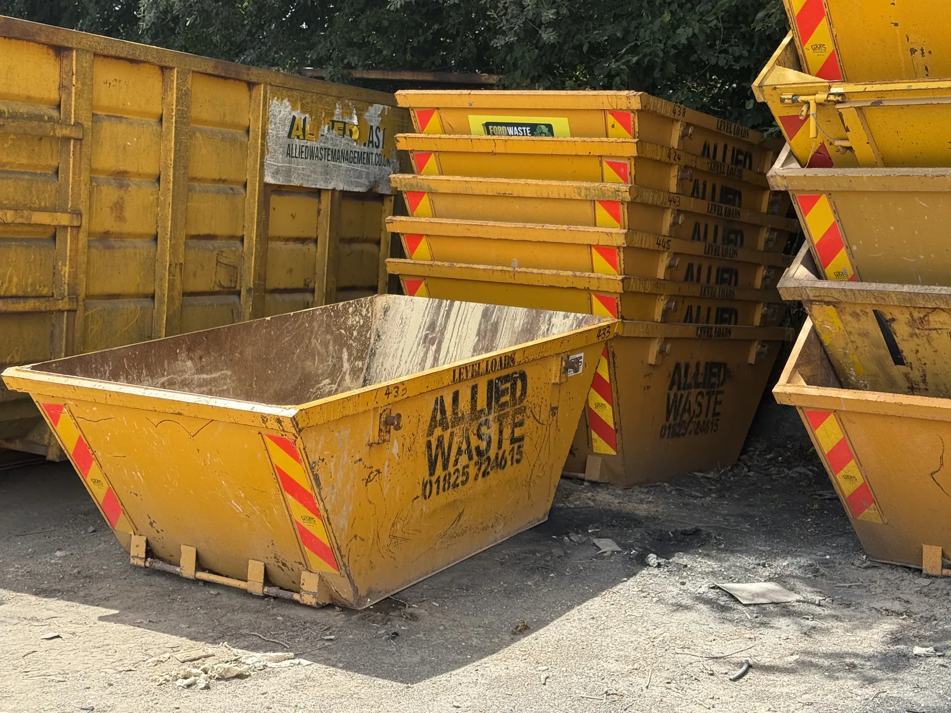 Stacked yellow skips at the Ford Waste yard in Uckfield, ready for delivery